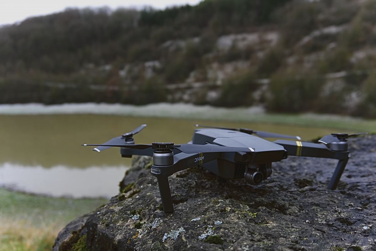 black quadcopter on rock
